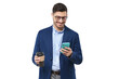 © Damir Khabirov - Businessman holding smartphone in one hand and takeaway coffee cup in another, looking at screen of phone