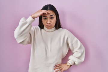 Canvas Print - Young south asian woman standing over pink background worried and stressed about a problem with hand on forehead, nervous and anxious for crisis