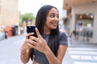 © Krakenimages.com - Young arab woman smiling confident using smartphone at street