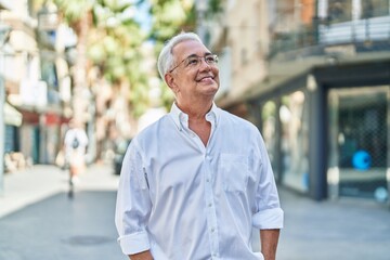 Poster - Middle age grey-haired man smiling confident looking to the sky at street