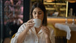 © Krakenimages.com - Young beautiful hispanic woman drinking coffee sitting on the table at the restaurant