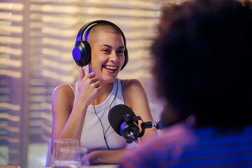 Wall Mural - A co-host is sitting in a home recording studio while showing thumbs up and preparing to go live on air.