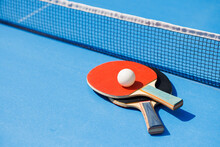 Tennis Rackets For Playing Ping Pong On Blue Table, Ping Pong Concept