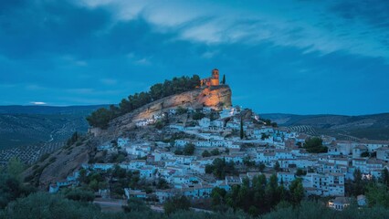 Wall Mural - Sunset time lapse of an ancient town with a Moorish castle on the hill top, Montefrio, Granada, Spain