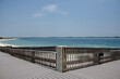 Wooden walkway leading to the beach and pier with view of the sea.  Beautiful view of Florida bay. White sand beaches and ocean blue waters. 