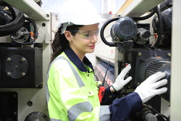 worker or engineer working in factory with safety uniform , safety hat and safety glasses , image is safety concept or happy workplace