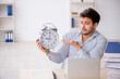 © Elnur - Young male employee in time management concept