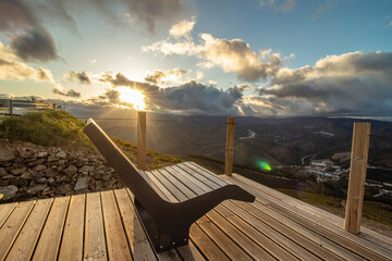 Empty garden bench during sunset, at the Cabeço da Urra viewpoint in the town of Pampilhosa da Serra, district of Coimbra, Portugal