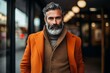 © Iigo - Portrait of a handsome bearded mature man in an orange coat.