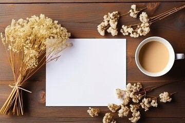 Poster - Flat lay view of blank paper card mockup on wooden table with coffee cup and vase of dried flowers