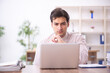 © Elnur - Young male employee and too much work in the office