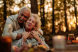 © bernardbodo - Married couple in love hugging in the forest while on picnic