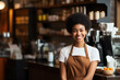 © vefimov - Woman standing in front of counter in coffee shop. This image can be used to depict customer ordering or waiting for their coffee.