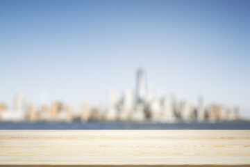 Wall Mural - Blank tabletop made of wooden planks with beautiful blurry cityscape in the afternoon on background, mockup