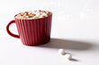 Red christmas mug of chocolate and marshmallows with copy space