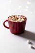 Vertical image of red christmas mug of chocolate and marshmallows with copy space