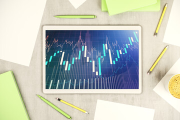 Modern digital tablet monitor with abstract creative financial chart, research and strategy concept. Top view. 3D Rendering