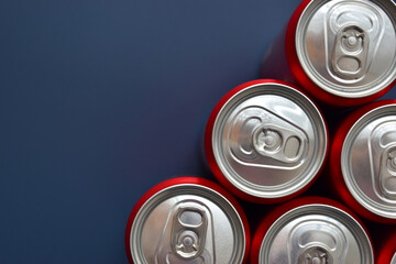 close up top of aluminium red cans soft drink put on blue texture background