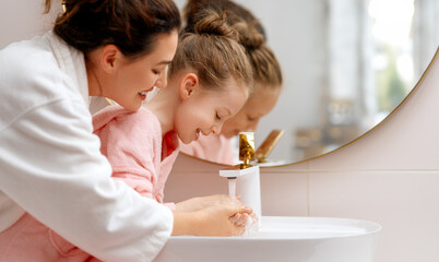 Wall Mural - girl and her mother are washing hands