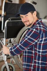 Wall Mural - man is repairing a wheelchair at workshop