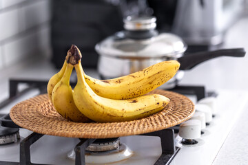 Sticker - A bunch of ripe bananas in a bright kitchen interior.