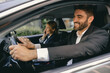 © Yaroslav Astakhov - Two positive business colleagues in suit carpooling journey into work together