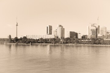 Wall Mural - Vienna cityscape with modern skyline seen from Danube. Austria architecture. Old postcard style - vintage paper sepia tone retro style.