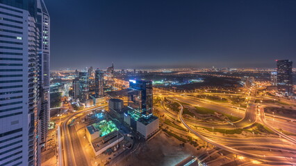 Wall Mural - Aerial view of media city and al barsha heights district area all night timelapse from Dubai marina.
