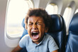 A distraught baby cries in an airplane seat.