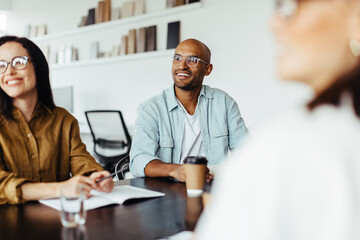 Poster - Creative business people listening to a group discussion in a meeting