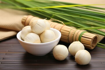 Poster - herbal compress balls placed next to lemongrass stalks