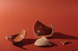 Details of broken ceramic cup on red background. Trendy hard shadows from broken pot, selective focus
