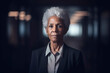 © epiximages - older, beautiful, black businesswoman standing alone in office