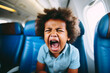 Toddler screaming on an airplane seat.
