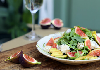 Wall Mural - fresh salad with figs and cheese and arugula