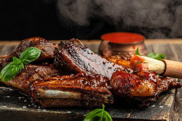 Wall Mural - Hot grilled pork ribs with sauce and smoke on a wooden board. Restaurant menu, dieting, cookbook recipe