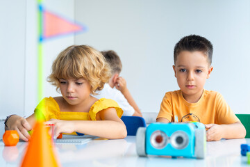 Wall Mural - robotics programming class. preschool children construct and code robot. stem education using constr