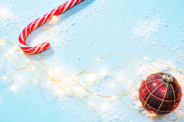 Poster - Candy cane, red Christmas ball and Christmas lights on blue. Winter holidays background