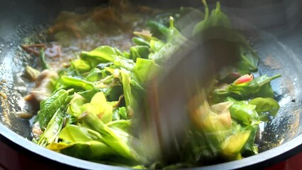 Sticker - Cooking Ficus leaves or Phuk Haud  curry in pot , Thai northern style curry.