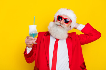 Poster - Photo of peaceful grandfather hand behind head hold drink glass x-mas eve isolated on yellow color background