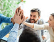 © Lumos sp - businessman businesswoman success young business team high five support unity celebrating give me five  office startup partnership diversity