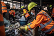 Female worker sorting trash material to be processed in a waste recycling plan with many colleagues in the background. Separate garbage collection.