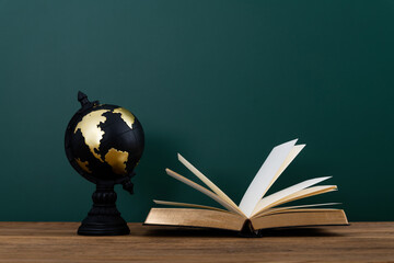 Wall Mural - Globe and book in front of the blackboard