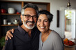 © flydragon - a happy couple in their forties pose in their kitchen