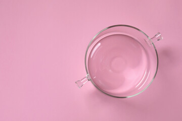 Wall Mural - Empty glass pot on pink background, top view. Space for text
