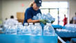 Volunteer prepares clean water bottles for charity