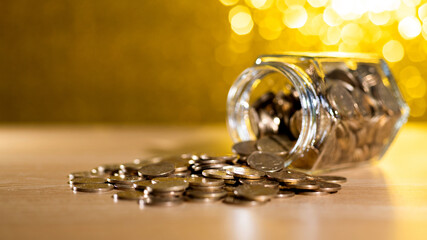 Wall Mural - Coins spilling from glass jar