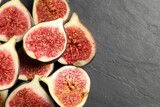 Fototapeta Kuchnia - Halves of fresh ripe figs on grey textured table, flat lay. Space for text