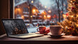  christmas cup of coffee on the table and laptop with view from window to cold snowy outside