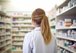 © DenisMArt - Young female pharmacist consultant at pharmacy between shelves with medicines.Macro.AI Generative